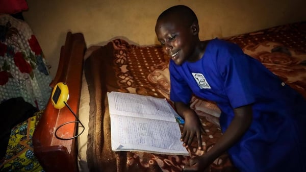 African student with donated solar light