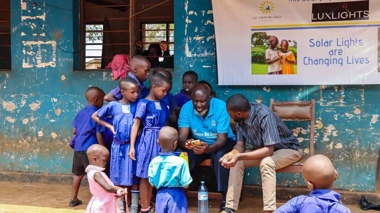 African teacher and students with donated light